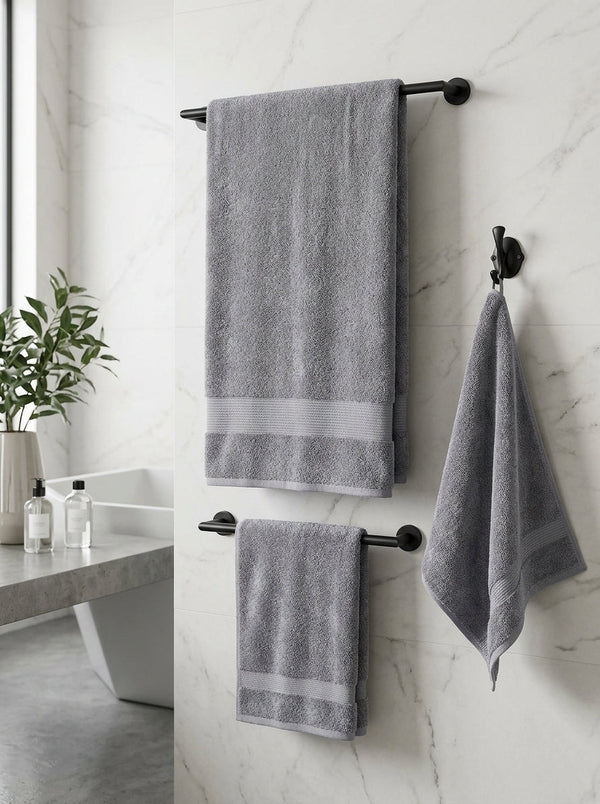 Veloury premium grey bath towels hanging on rack in modern bathroom